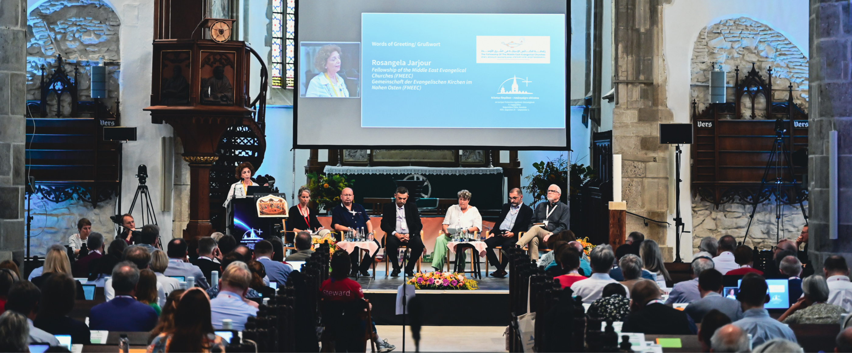 Menschen bei einer Podiumsdiskussion